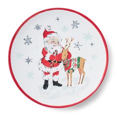 a plate with a santa clause holding a deer on it's back and snowflakes around the edges