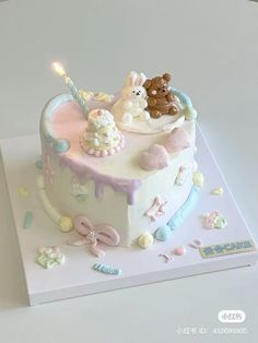 a birthday cake decorated with teddy bears and other decorations