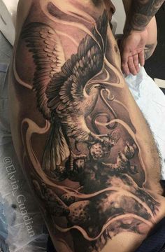 a man with an eagle tattoo on his stomach