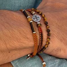 Beautiful trendy "protection" bracelet for men for a chic and casual look 3-row bracelet, hand-woven with different knots, made in 🇫🇷 Multicolored braiding yarn Natural tiger's eye stone and jasper Silver plated cross medal with patina (made in Europe) Stainless steel and tiger eye washers Tiger's eye beads 4 mins, wood jasper 6mm Two sizes available. Size 1 from 17.5 to 18.9 cm (standard size) Size 2 from 19 cm to 21.5 cm (⚠️large size) Please check your wrist size and respect my dimensions. Less than 19 cm wrist size = Size 1 TIP: To know your wrist size, take a string or a tape measure, wrap it around your wrist and measure. Size 1 fits most men, it is the best-selling size. (The models in the photos are wearing size No. 1) Non contractual photo Natural stones, each piece of jewelry i Diy Man Bracelet, Men Stone Bracelet, Bracelet Photo, Masculine Jewelry, Diy Bracelets Easy, Gemstone Beads Jewelry, Diy Bracelets Patterns, Diy Bracelet Designs, Beaded Jewelry Designs