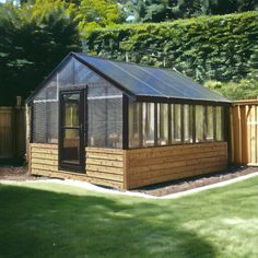 a small wooden building sitting in the middle of a yard