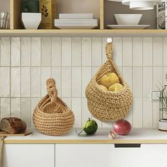 two baskets with apples in them sitting on a counter