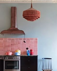 a stove top oven sitting inside of a kitchen next to a wall mounted range hood