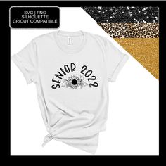 a white t - shirt with sunflowers on the front and gold glitter in the background