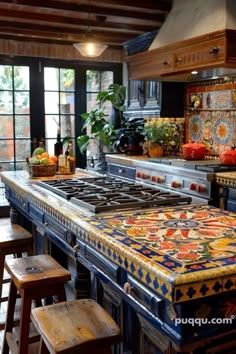 a kitchen with an island counter and stools in front of the stove top, surrounded by potted plants