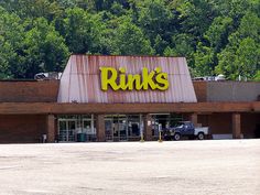 an empty parking lot in front of a store with the words punks on it