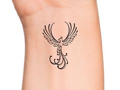 a small tattoo on the ankle of a woman's foot with a bird design