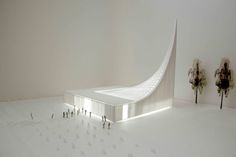 people are standing in the middle of a room with a large white structure on it