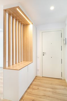 an empty room with wooden stairs and white walls