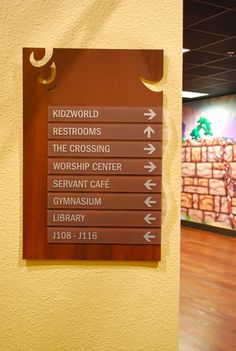 there is a sign on the wall pointing to different places in the world that you can see