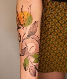 a woman's arm with a flower tattoo on the left side of her body