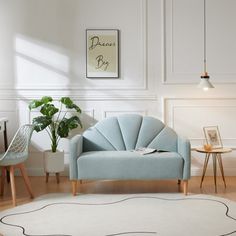 a living room filled with furniture and a rug on top of a hard wood floor