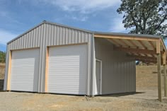 two garages in the middle of a field with one door open and another closed