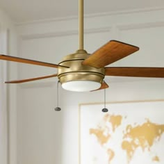 a ceiling fan in a living room with a world map on the wall behind it