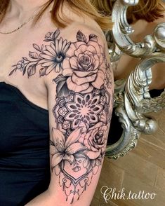 a woman's shoulder with flowers on it