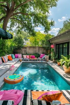 an outdoor pool with colorful pillows and furniture