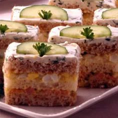 several slices of cake with cucumbers on top