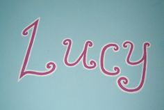 the word lucia written in pink on a blue background