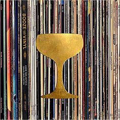 a gold cup sitting on top of a pile of records