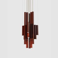 a wind chime hanging from the ceiling with several wooden sticks attached to it's sides