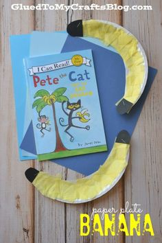 a paper plate with a banana on it and a book in the shape of a cat