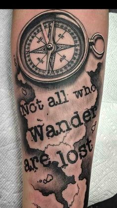 a man's arm with a compass tattoo on it and the words, not all who wander are lost