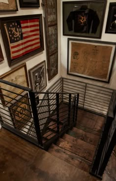 a staircase with metal handrails and pictures on the wall