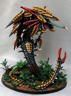 a statue of a bird with spikes on it's head and claws in its beak