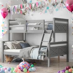 there is a bunk bed in the room with balloons and streamers on the wall