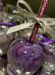 some purple candies wrapped in plastic and tied with ribbon