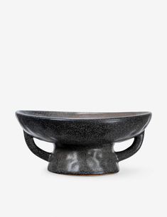 a black bowl sitting on top of a white table