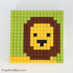 a lego lion head made out of green and yellow bricks