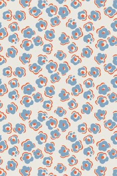 an orange and blue flower pattern on a white wallpaper with red circles in the center