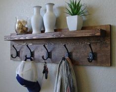 a wooden shelf with hooks and hats on it