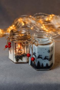 two glass jars with christmas decorations on them