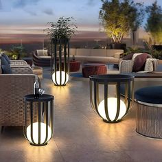 outdoor furniture is lit up at night on the patio