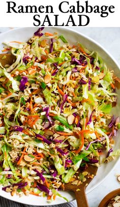 a white bowl filled with coleslaw slaw and topped with almonds on top