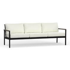 a black and white couch sitting on top of a white floor