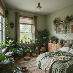 a bedroom with lots of plants in the window sill and on the bed is a green comforter