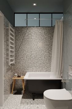 a bathroom with a toilet, bathtub and towel rack