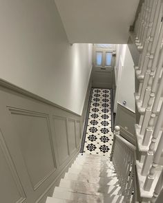 the stairs are lined with black and white tiles