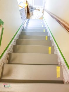 the stairs are painted with yellow tape and have been stripped off to make way for new carpet