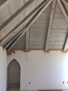 the inside of a room with white walls and wood beams on it, is shown in an instagram