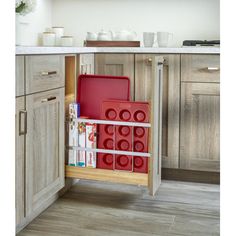 an open cabinet in a kitchen filled with dishes and utensils