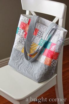 a bag sitting on top of a white chair next to a wooden floor and wall