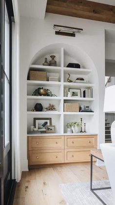 a living room filled with lots of white furniture