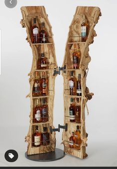 two wooden shelves with bottles on them and one is made out of tree trunks,