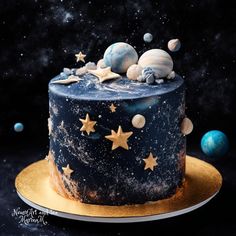 a space themed cake with stars and planets