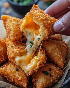 someone is dipping cheese into some fried food