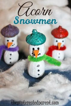 three snowmen made out of clay sitting in the snow with text overlay that reads acorn snowmen